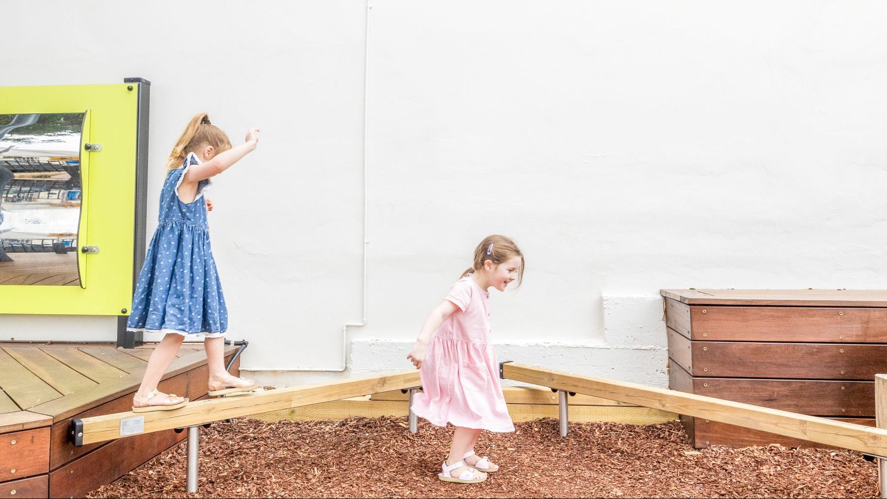 Children playing on balance beam