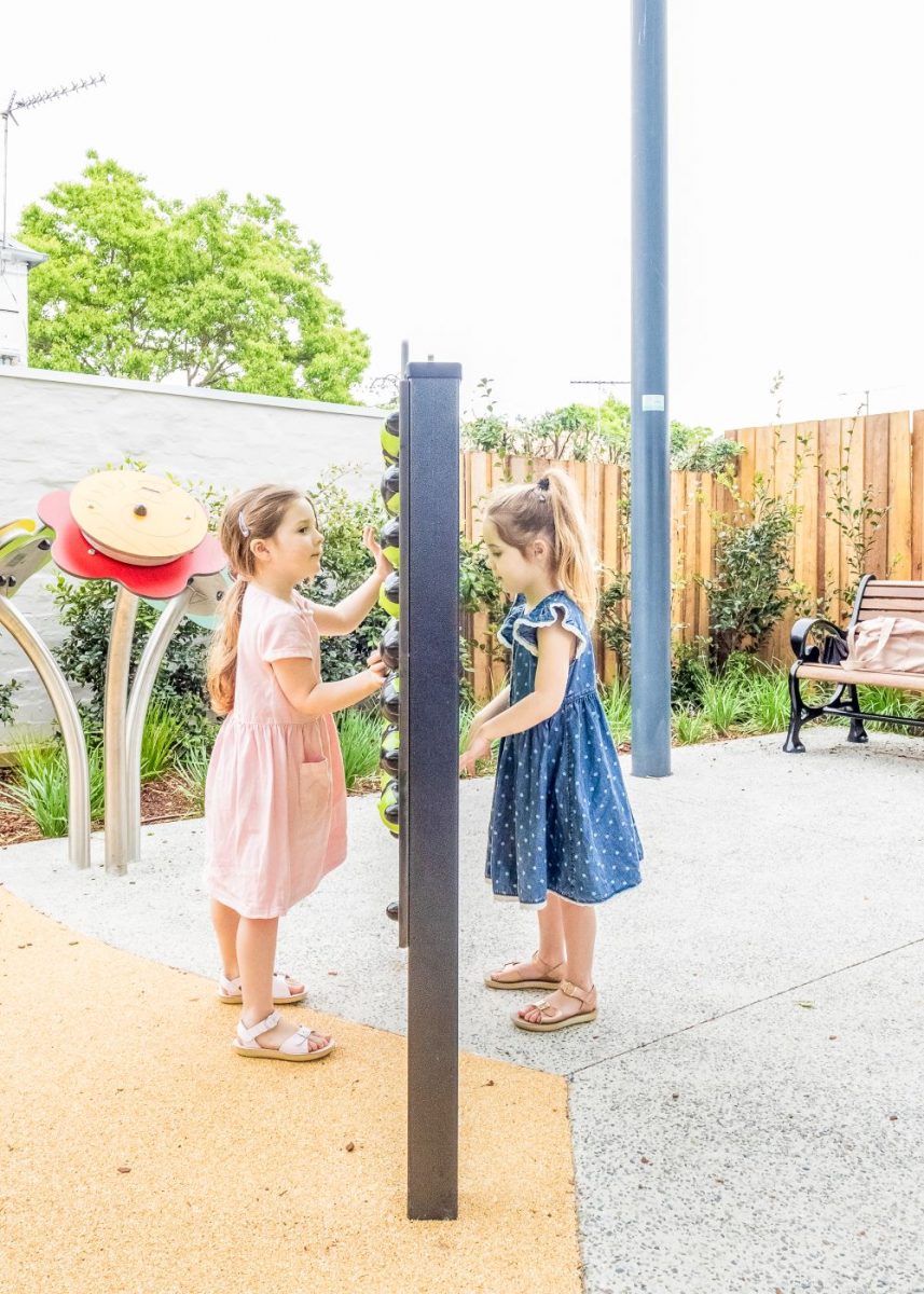 Toddlers playing with Abacus Play Panel at Spring Street Toddler Playground